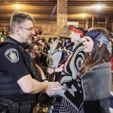 AbbyPD Officer shakes the hand of one of the Indigenous Role Models