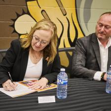 Two leaders signing the new enhancement agreement